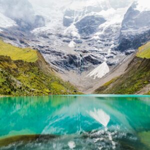 body of water with green mountains during daytime